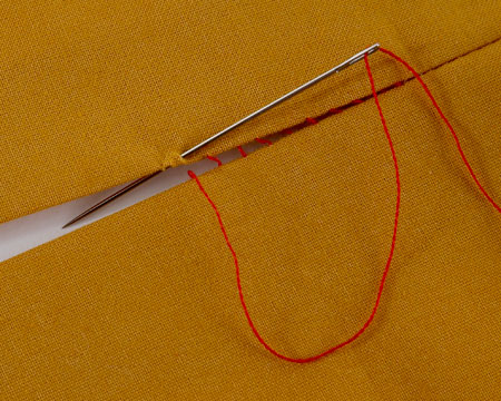 Small ladder stitches closing a seam